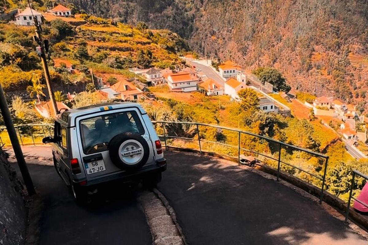 a jeep driving down a road on a mountain