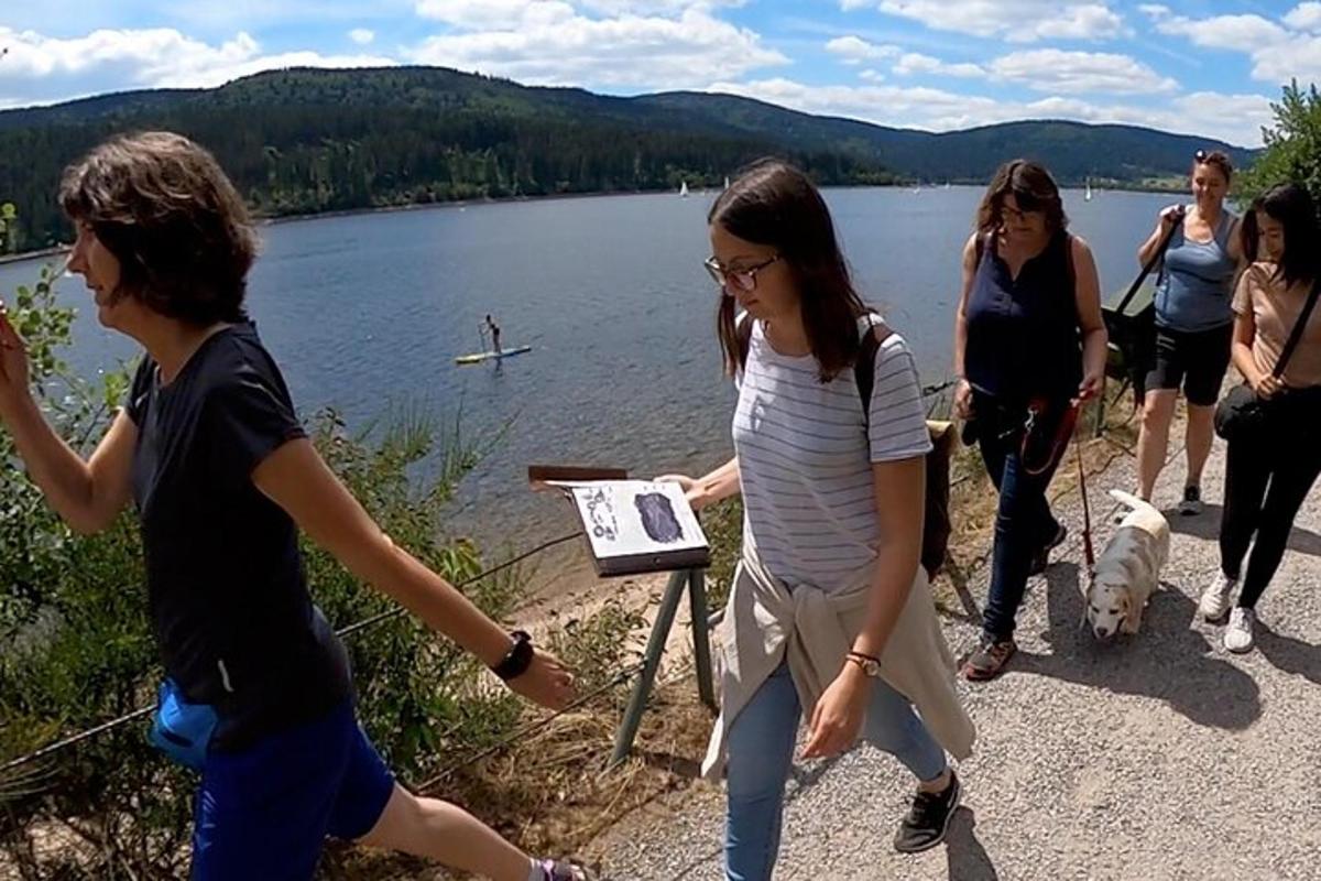 a group of people walking around a lake