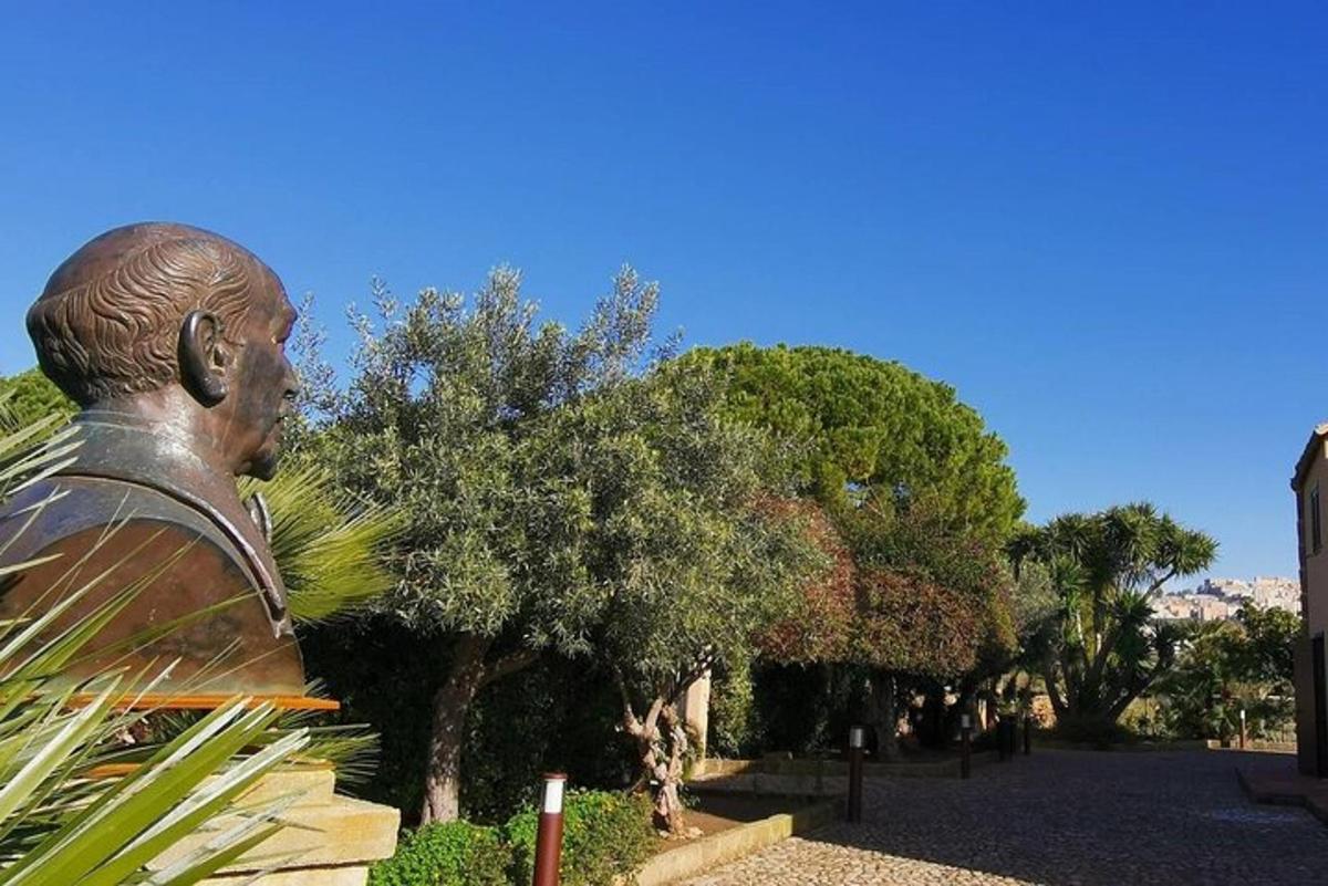 a statue of a man standing next to trees