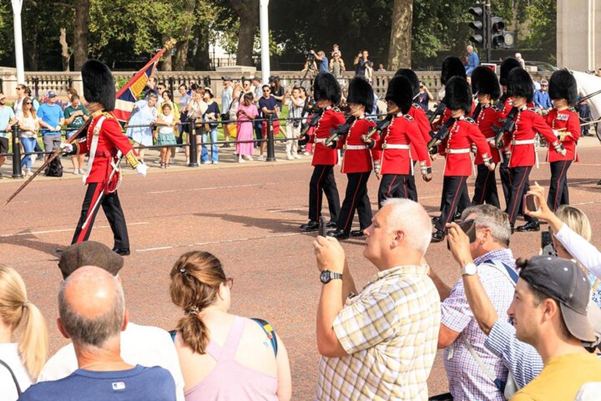 a group of people taking pictures of a marching band