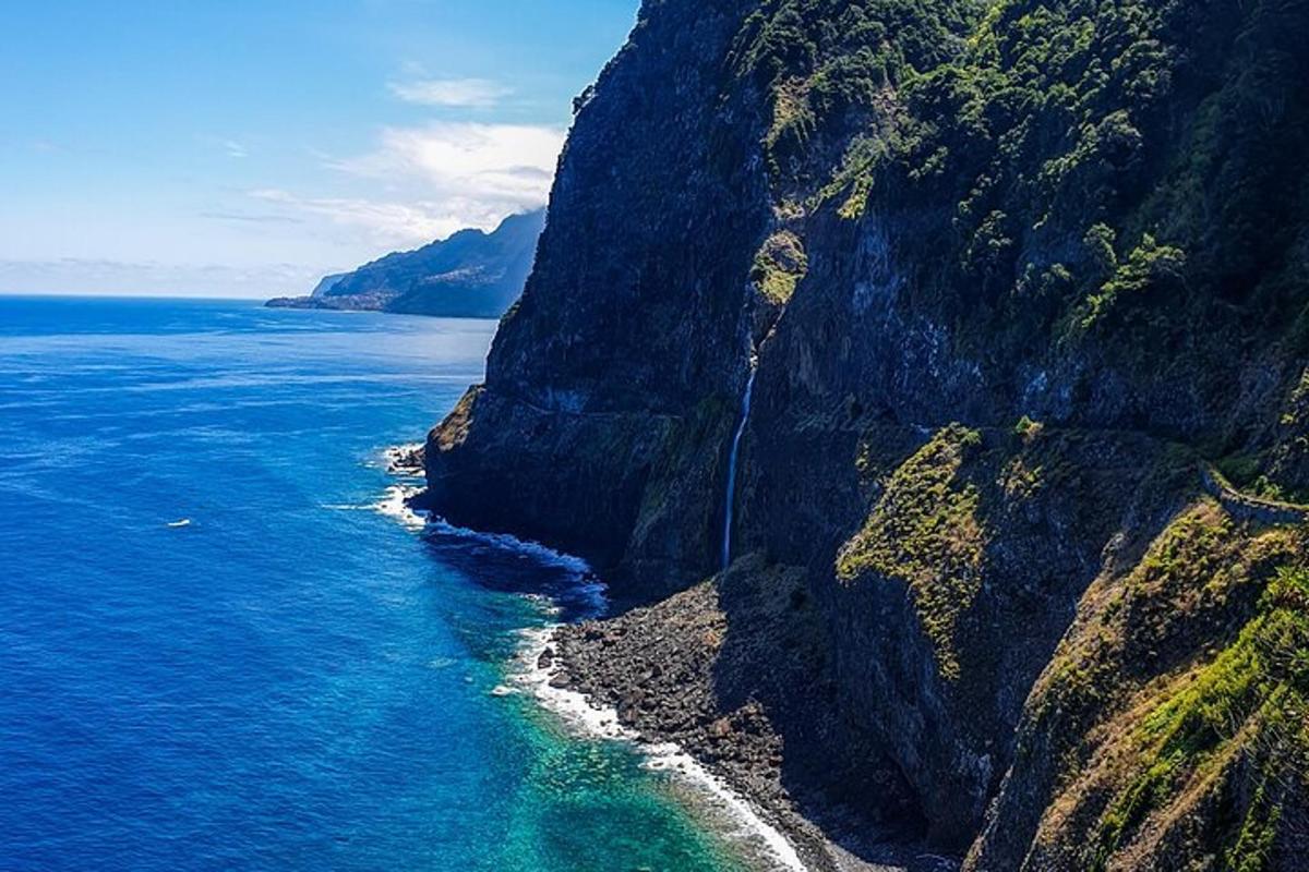 an aerial view of the ocean and a rocky coastline