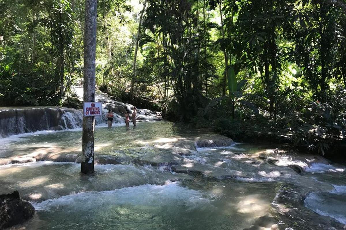tanda di tengah sungai dengan air terjun