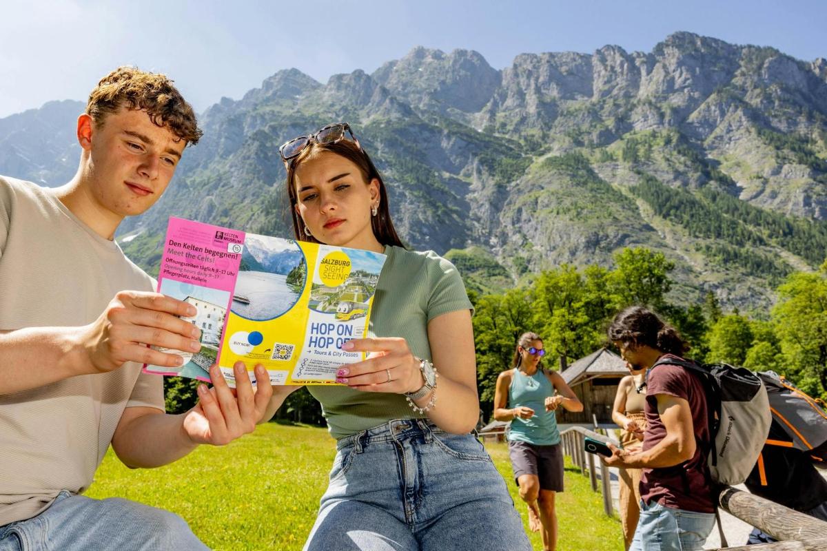 a man and a woman looking at a magazine