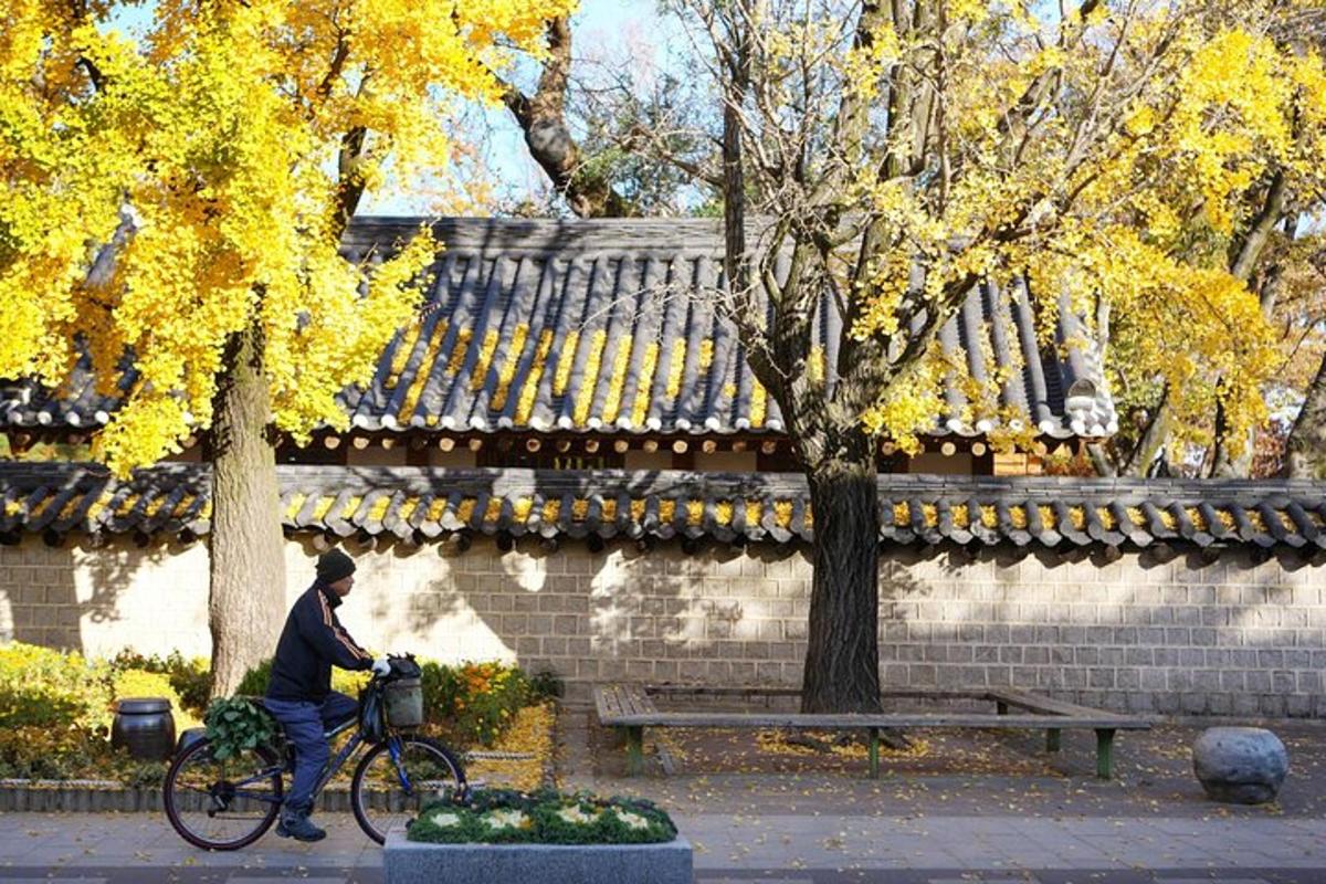 a man riding a bike next to a bench