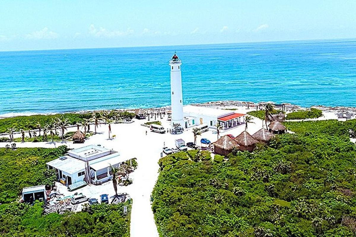 an aerial view of a lighthouse next to the ocean