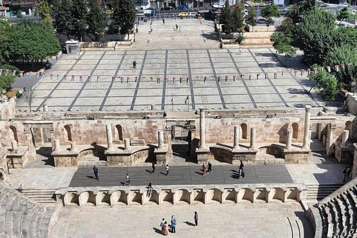 a group of people walking around an amphitheater
