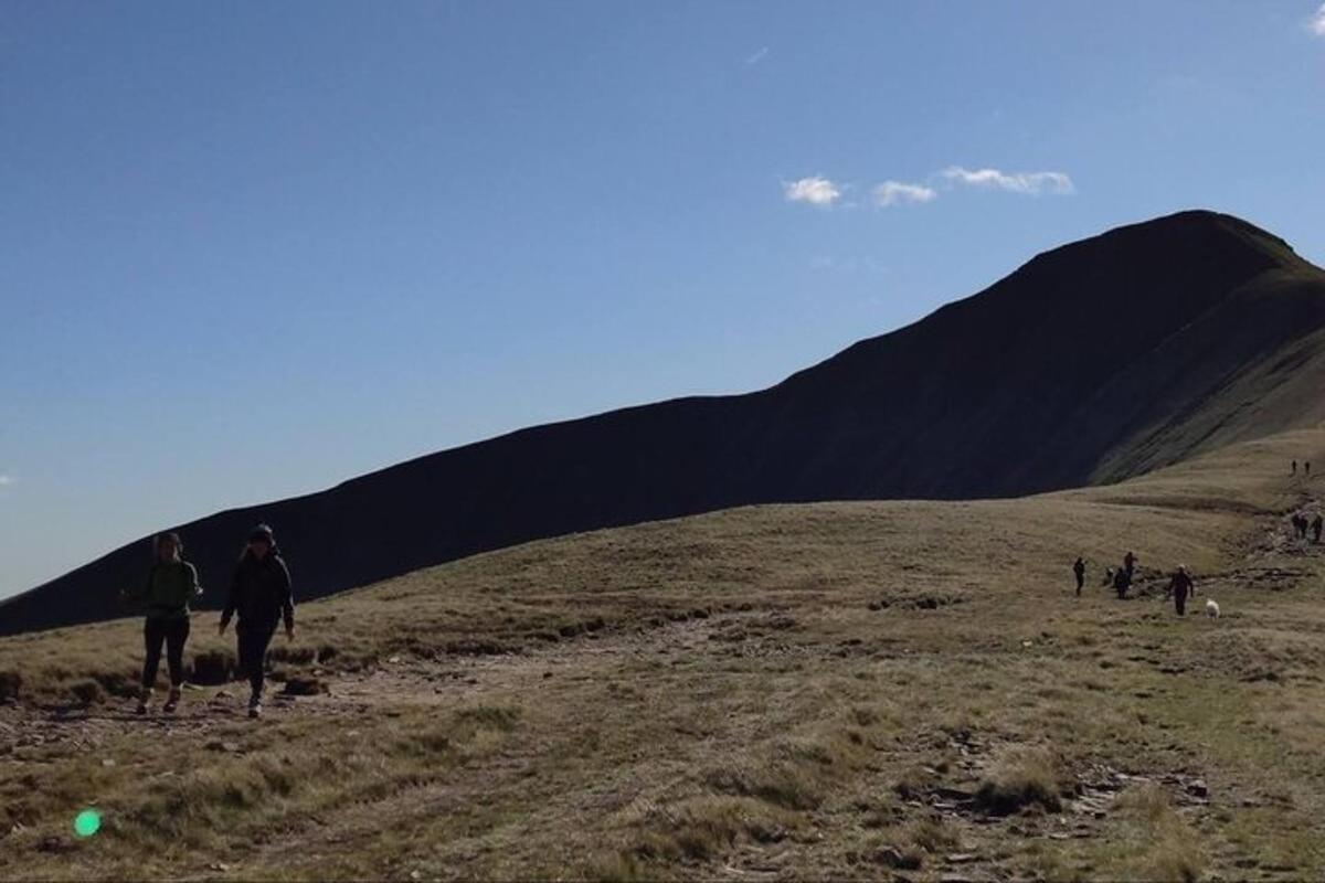 a group of people walking up a hill