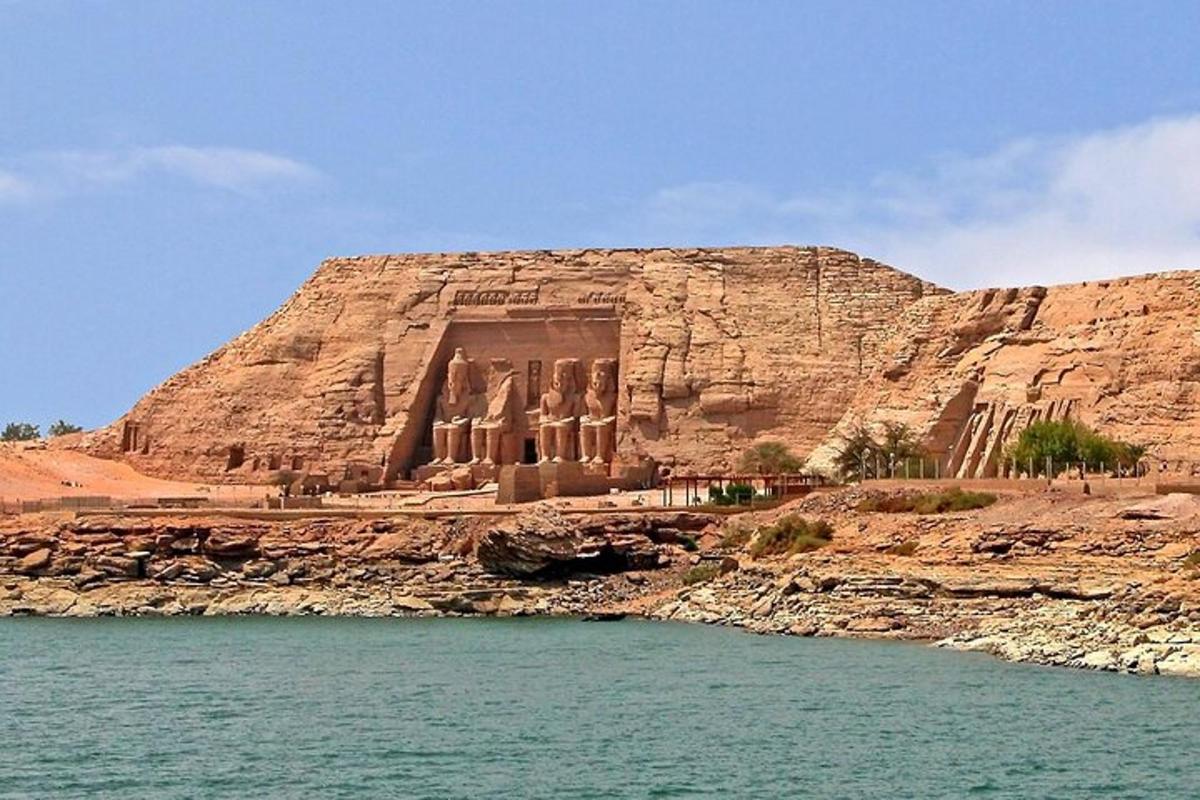 an ancient building on the side of a cliff