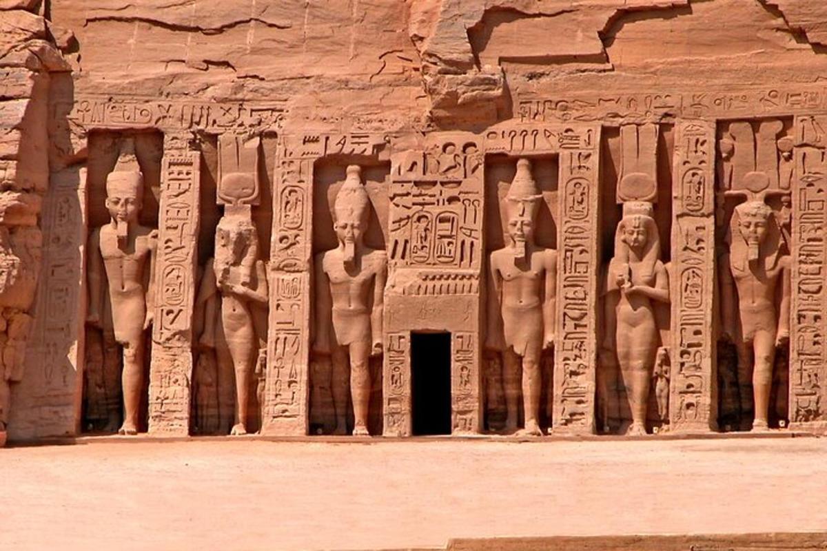 a stone wall with reliefs of people on it