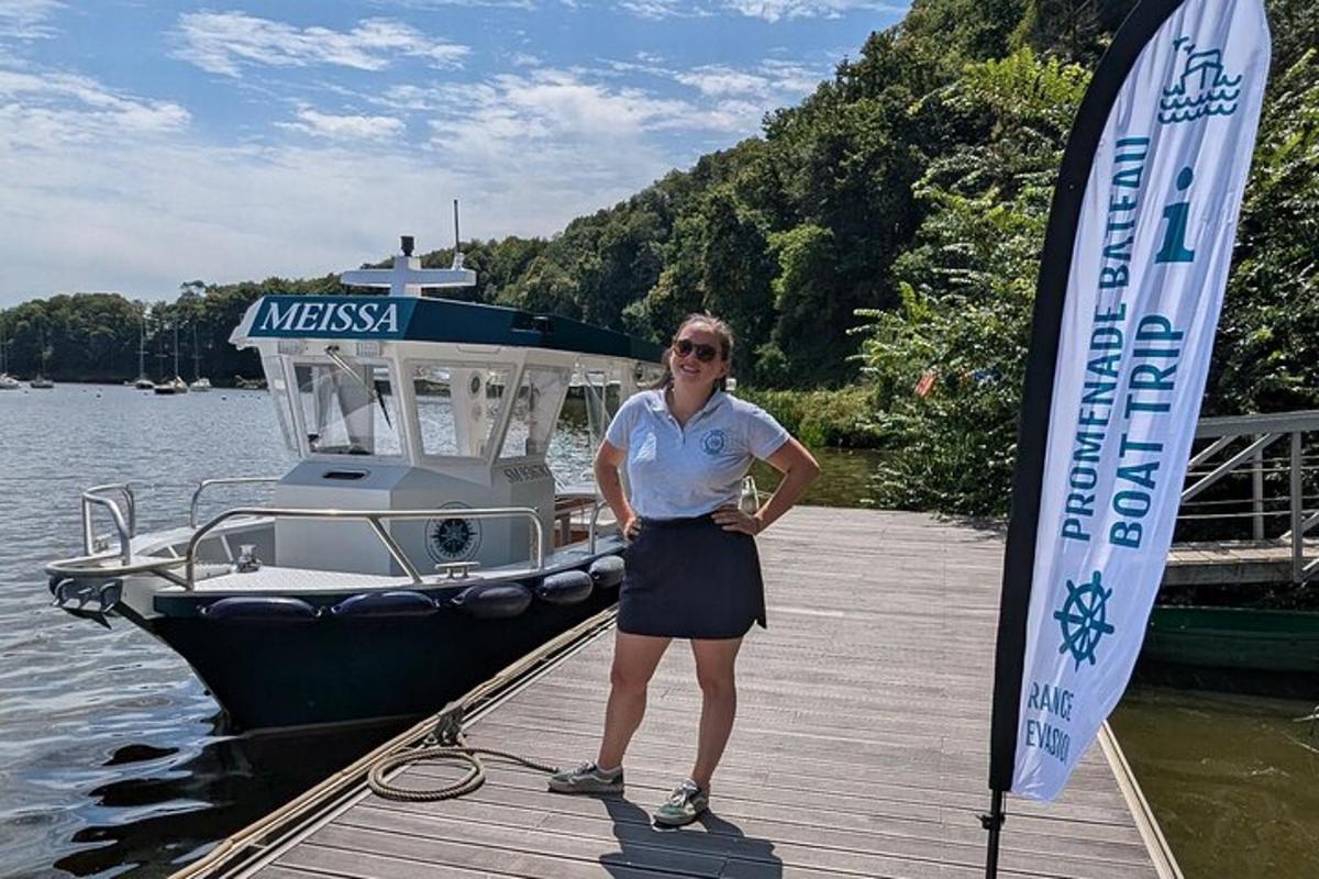 a woman standing on a dock next to a boat