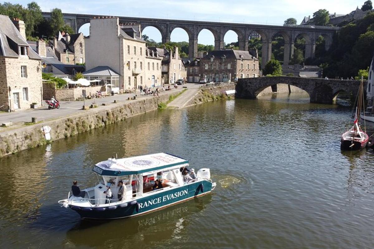a boat on a river with a bridge in the background