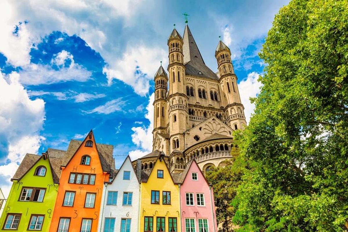 a group of colorful houses in front of a castle