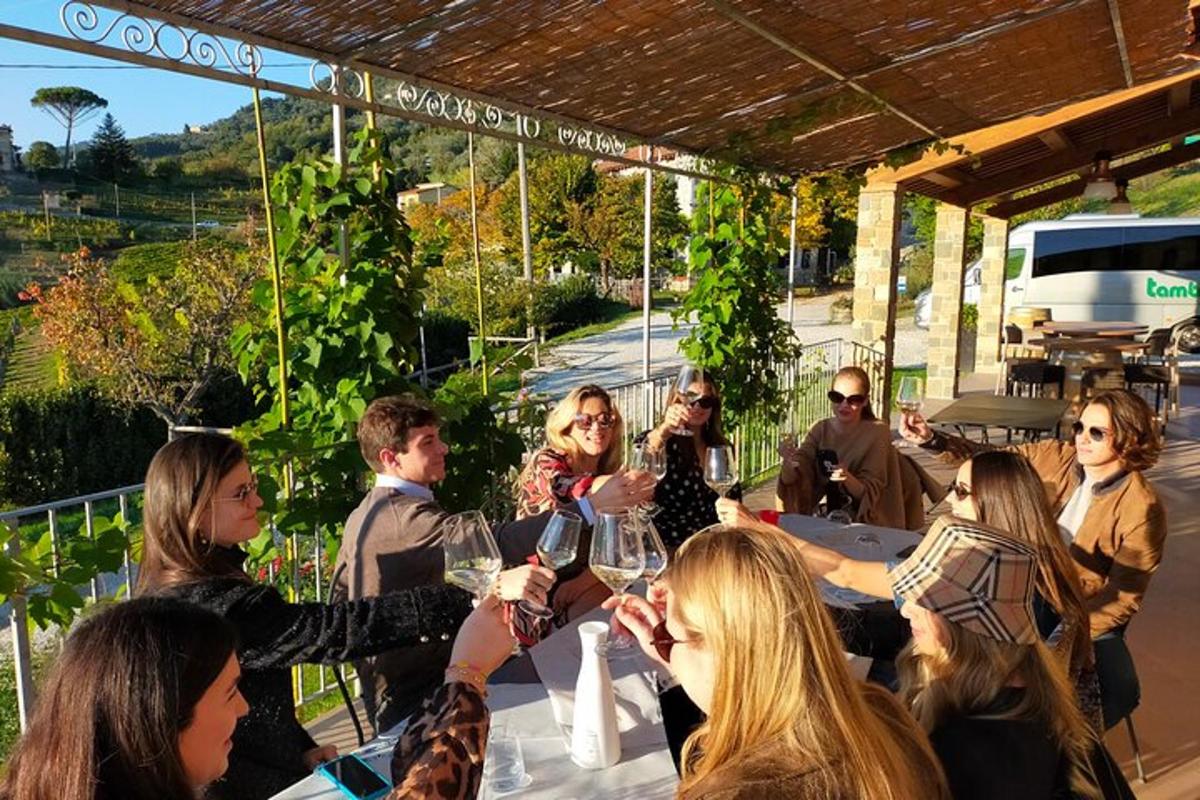 um grupo de pessoas sentadas à mesa com taças de vinho