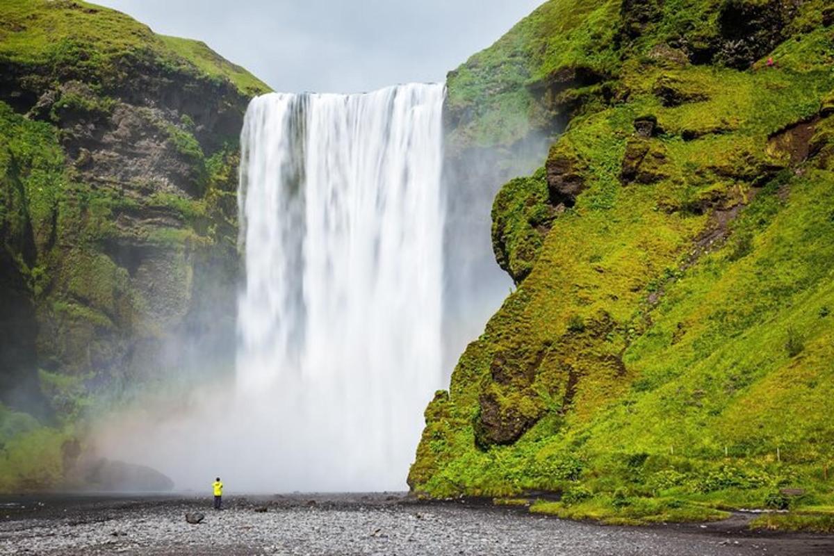 a person standing in front of a waterfall