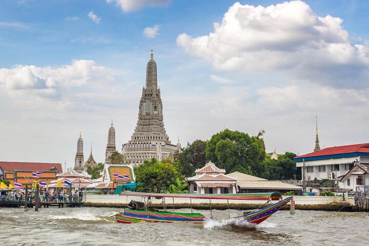 a boat in the water in front of a temple