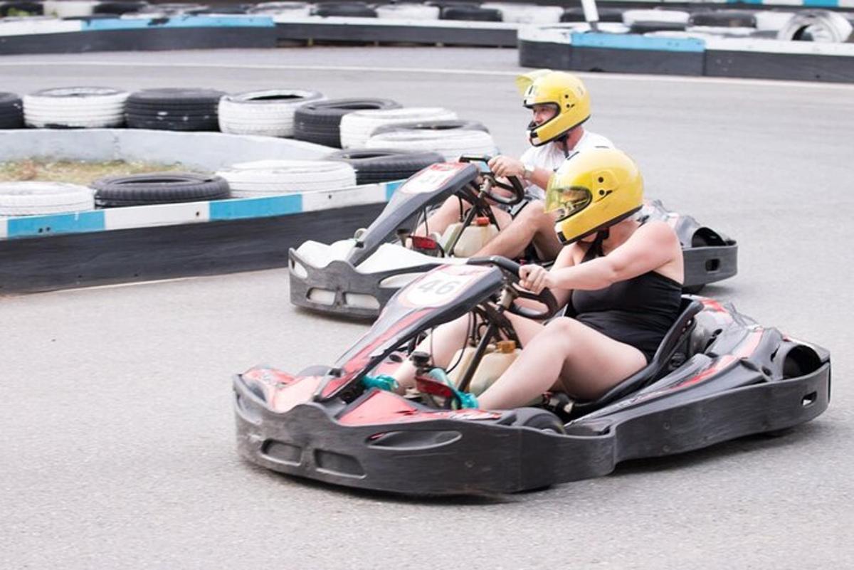 two people riding on a two wheeler on a track