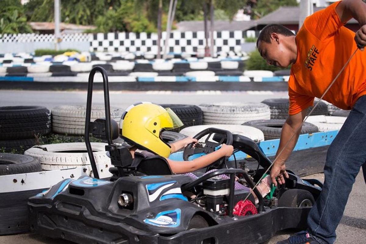 a man is putting a child in a toy car