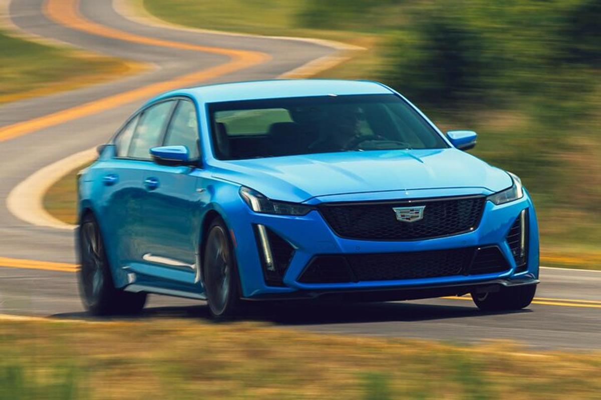 a blue car is driving down a road