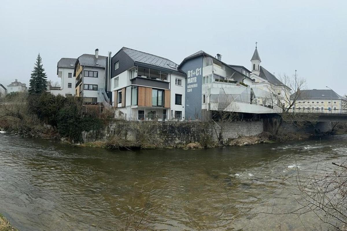 a building next to a river with a bridge