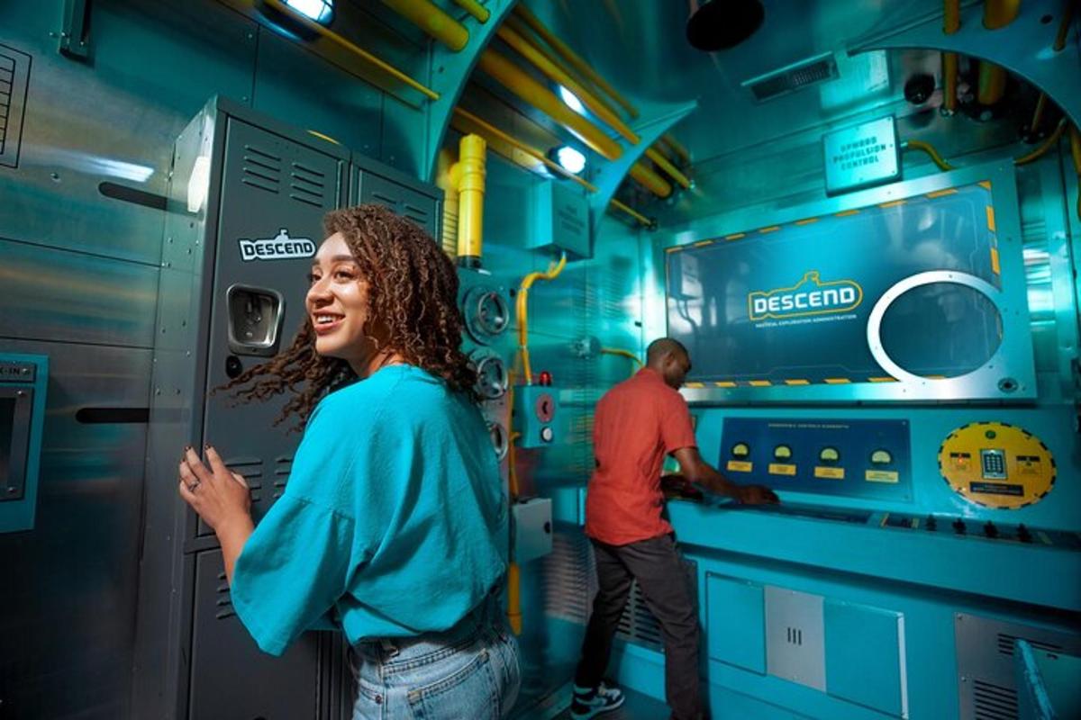 a woman standing inside of a train with a man working