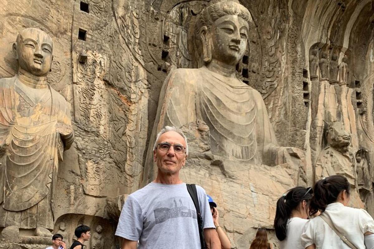 a man is standing in front of a statue