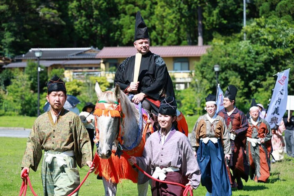 a group of people standing around a man on a horse