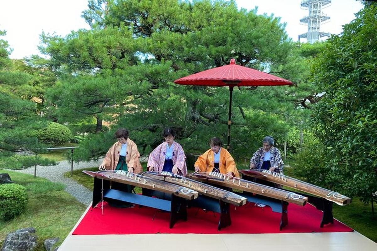 a group of women sitting at a table with an umbrella