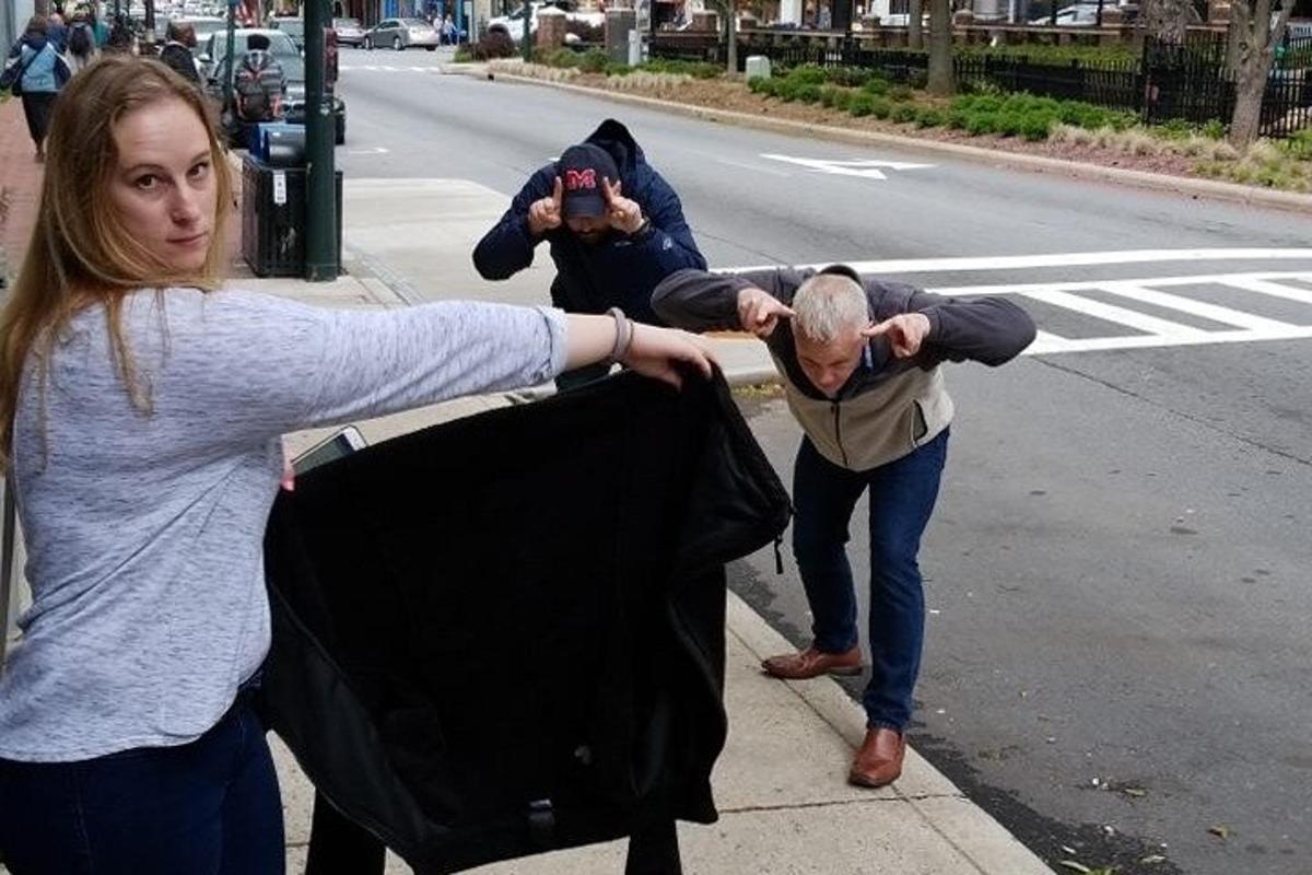 a group of people standing on the side of a street