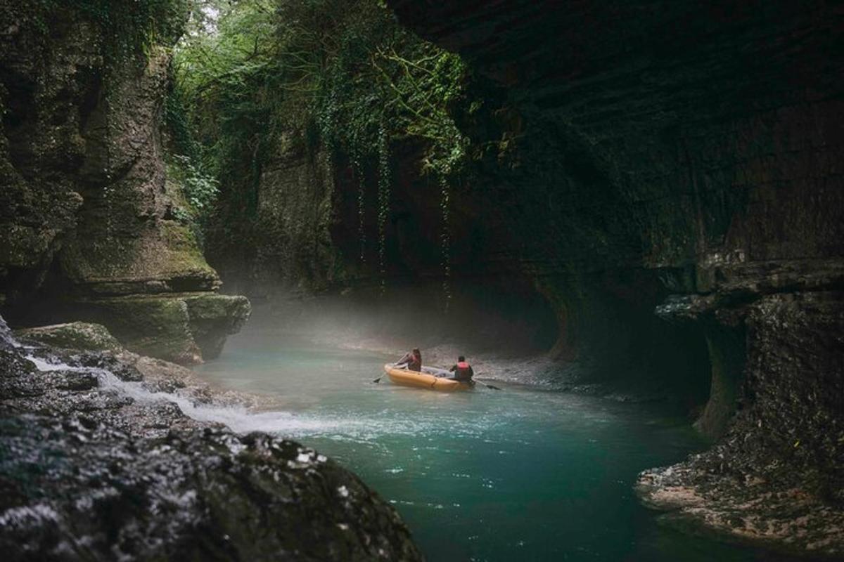 two people are in a boat in a river