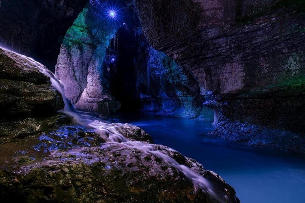 a cave with a stream of water in it