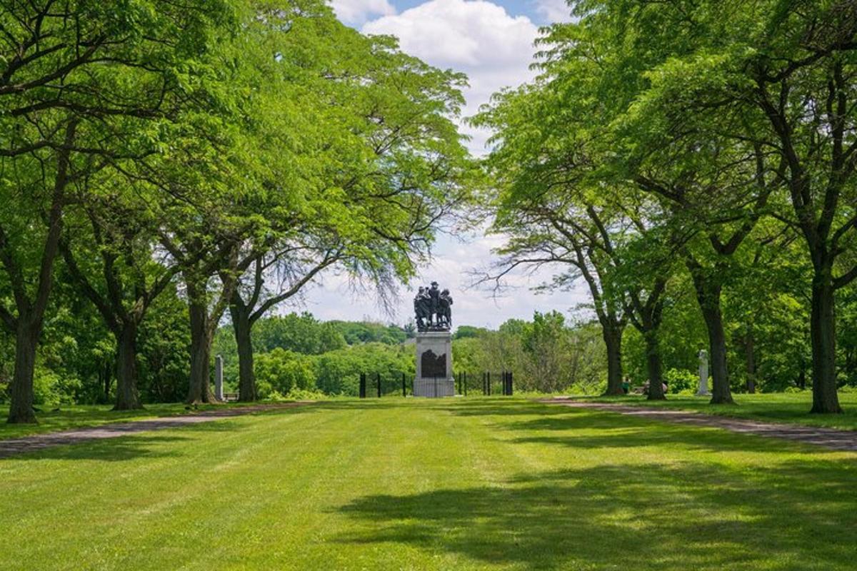 a park with a statue in the middle of a field