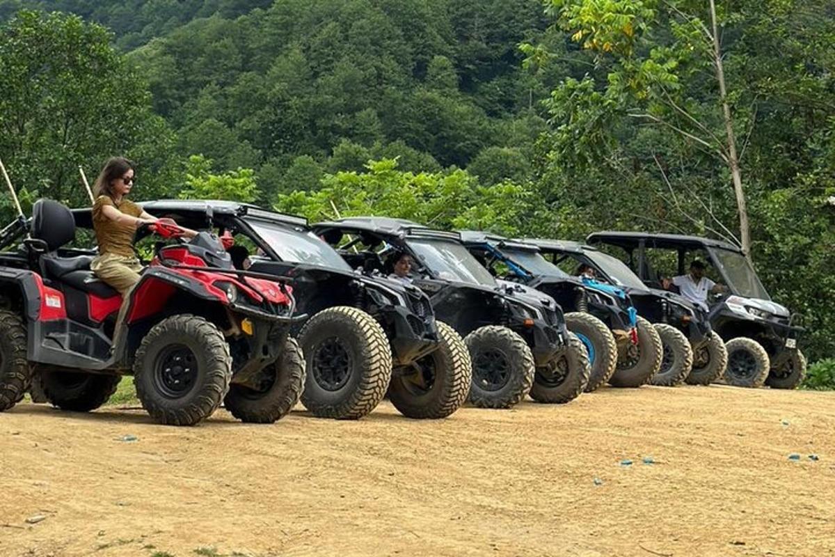 a line of atvs parked in a row on a dirt field