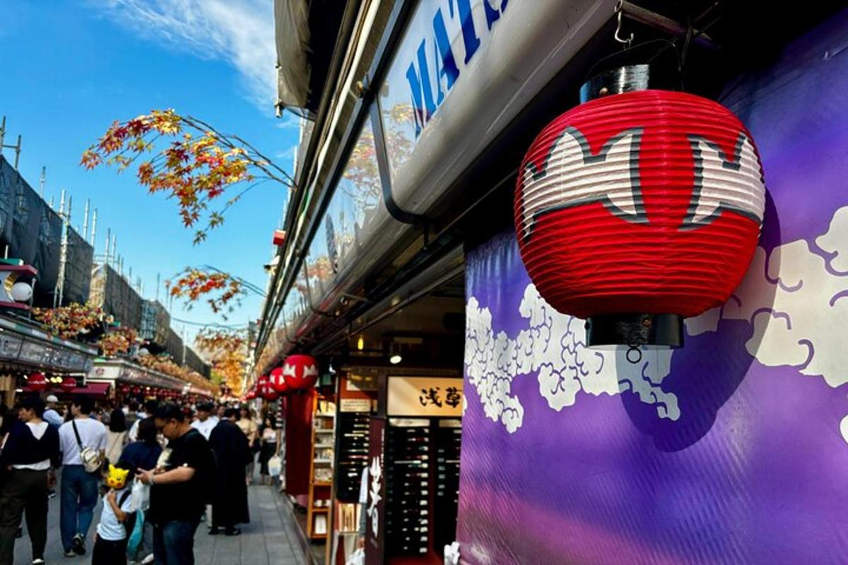 a red lantern hanging from the side of a store