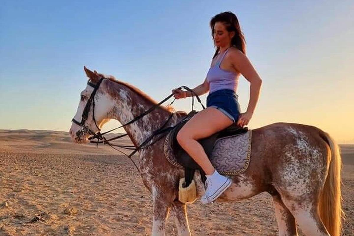 žena jazdiaca na koni v púšti