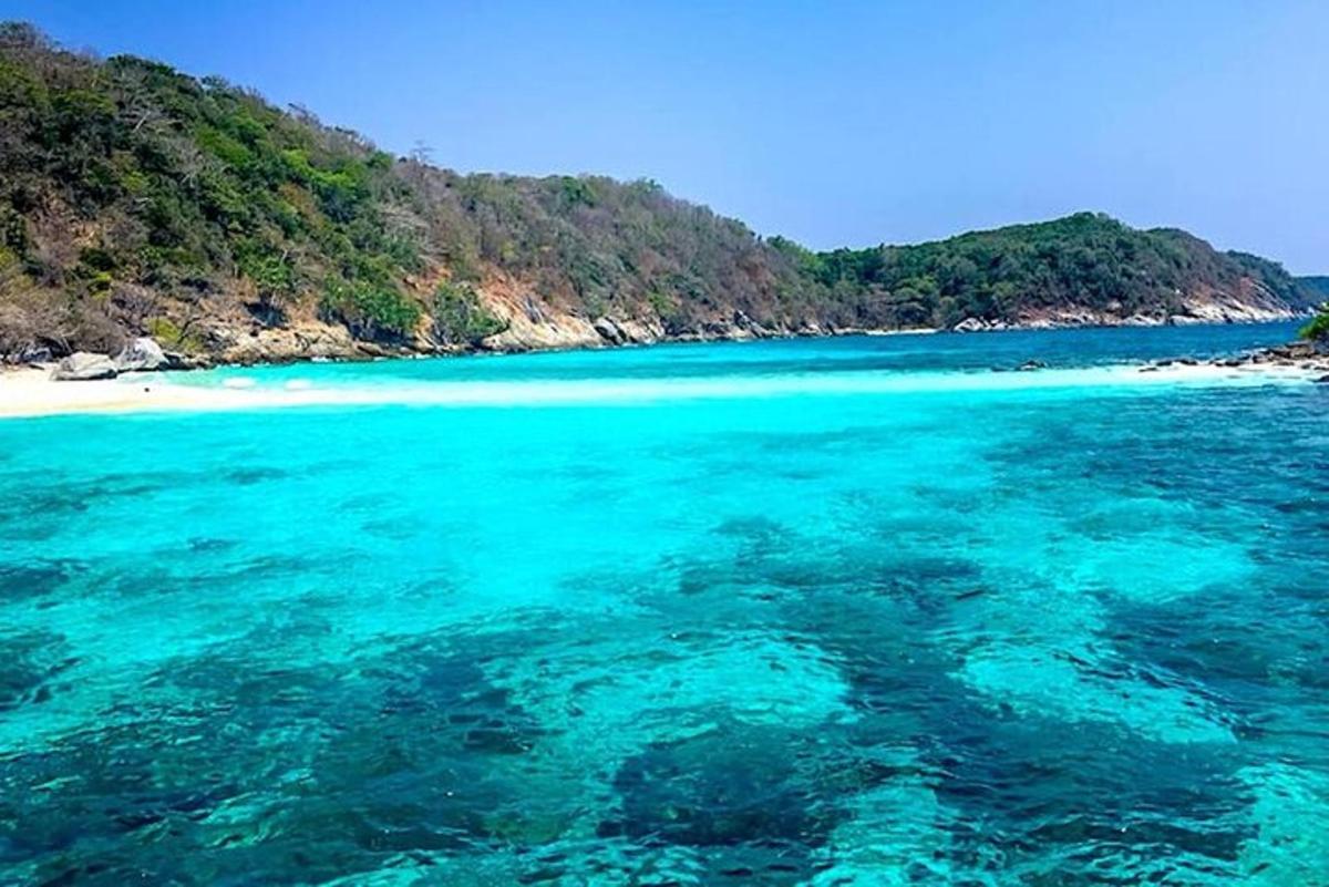 a view of a beach with turquoise water