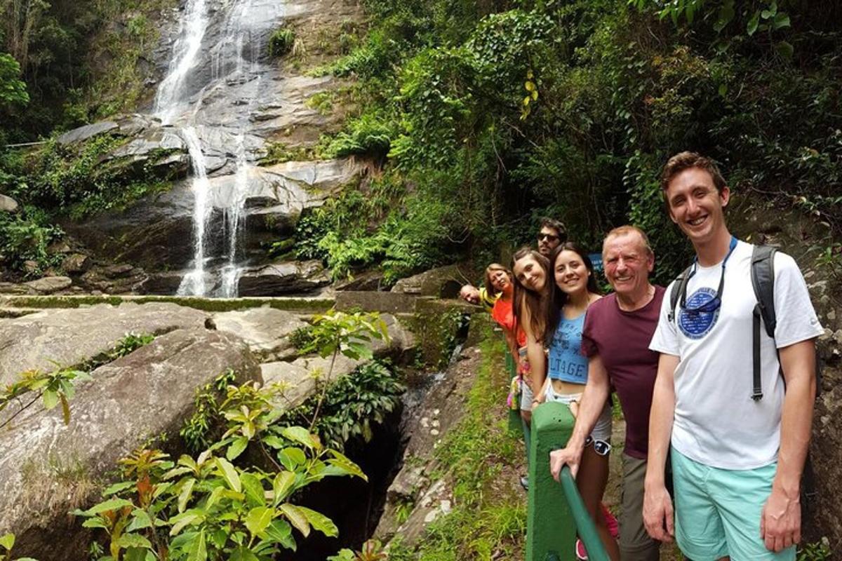 un groupe de personnes debout devant une cascade