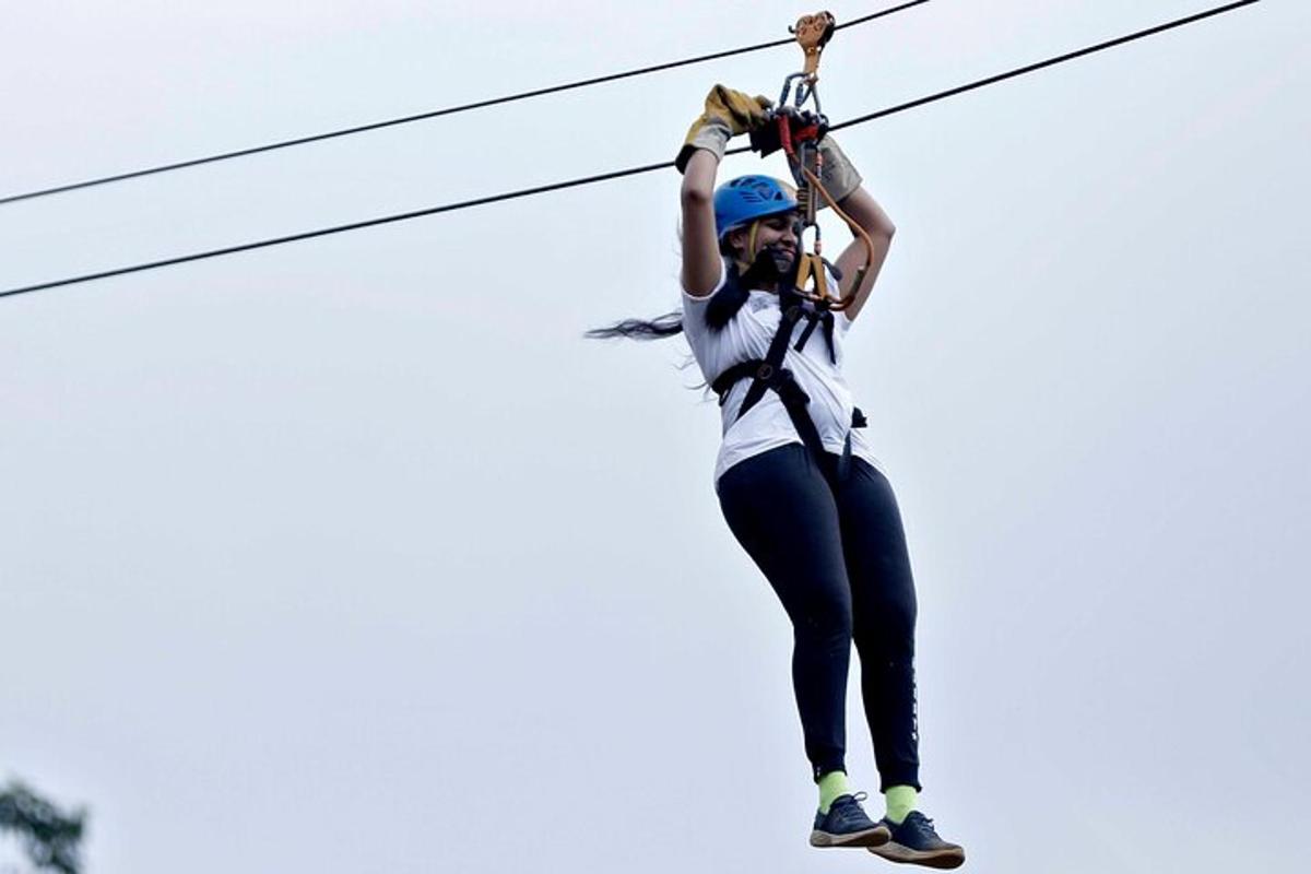 a woman is hanging on a zip line
