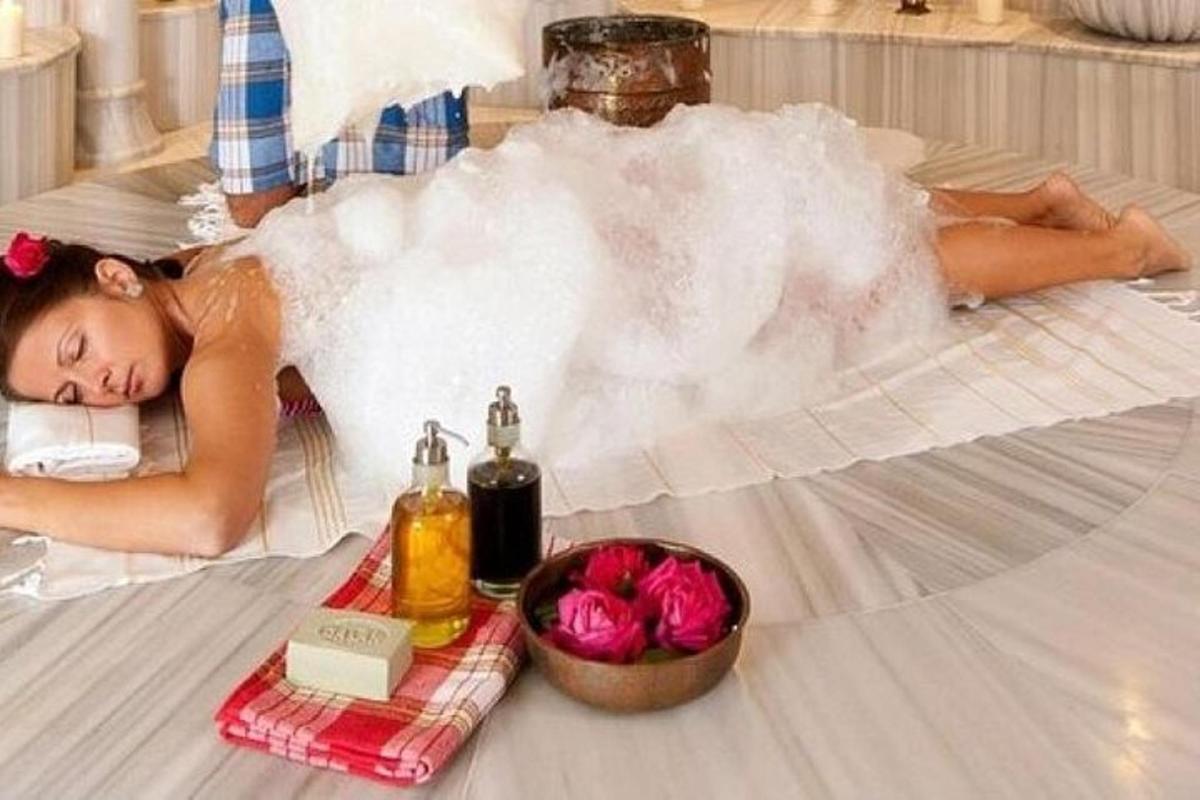 một người phụ nữ nằm trên giường với một đám hơi nước