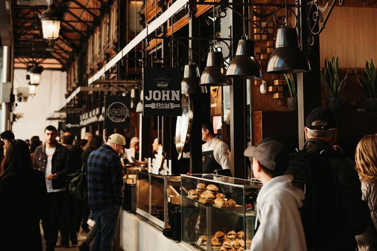 a group of people walking around a market with food