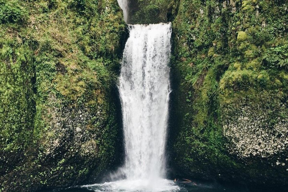 a waterfall on the side of a rock wall