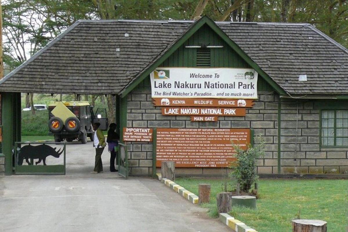 a building with a sign in front of a park