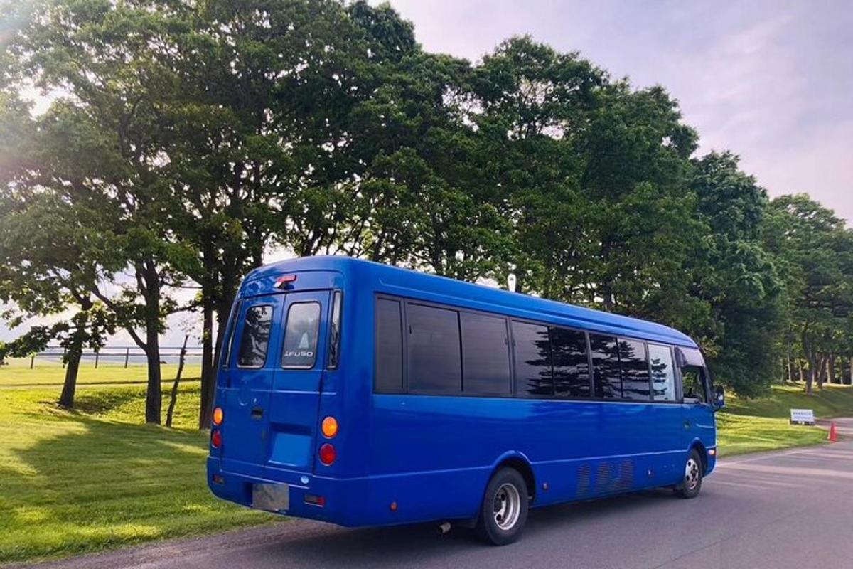 a blue bus is driving down a street