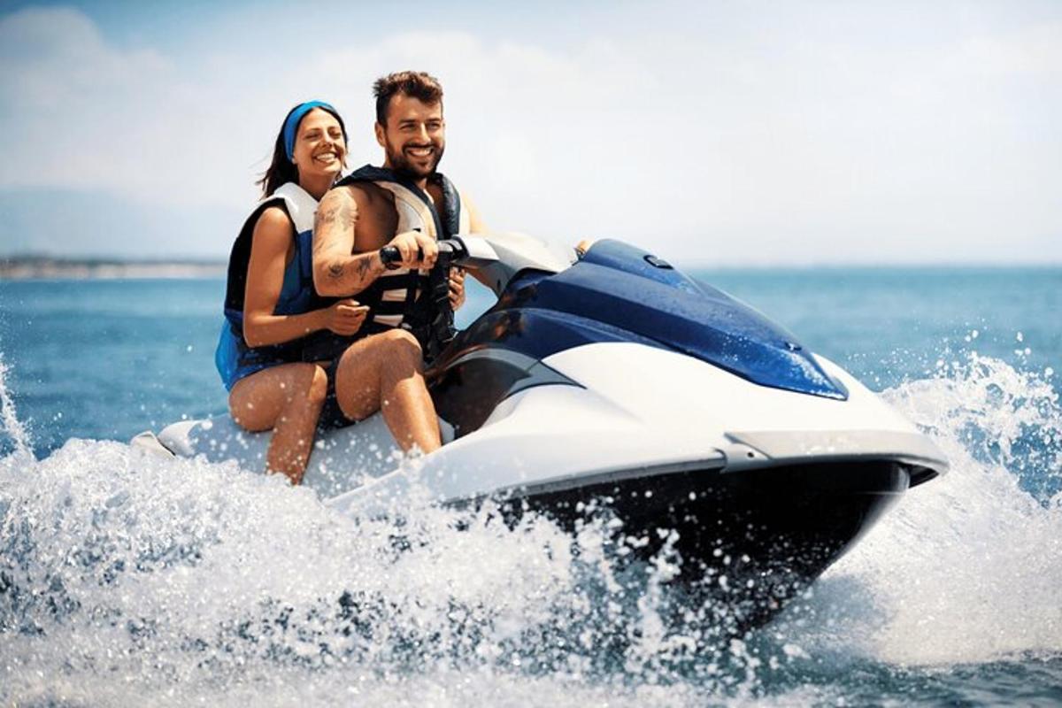a man and woman riding on a jet ski in the water