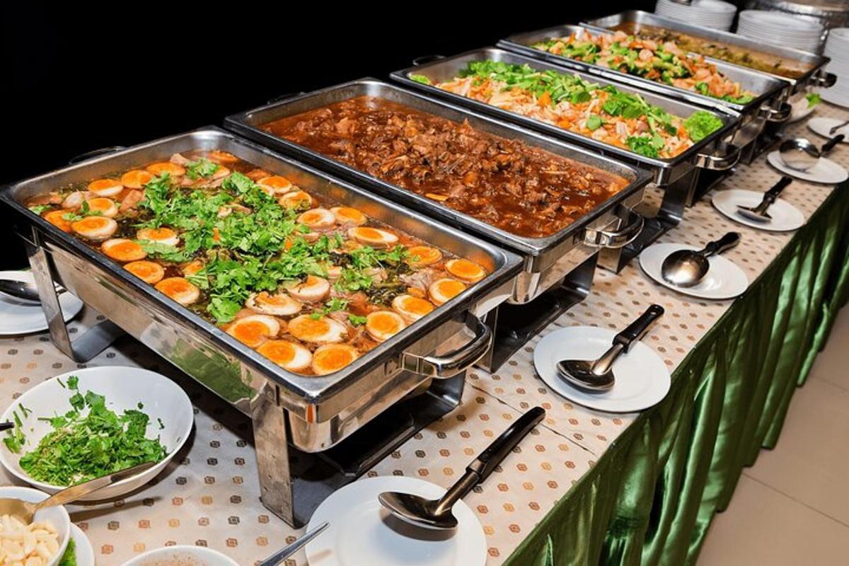 a buffet with several trays of food on a table