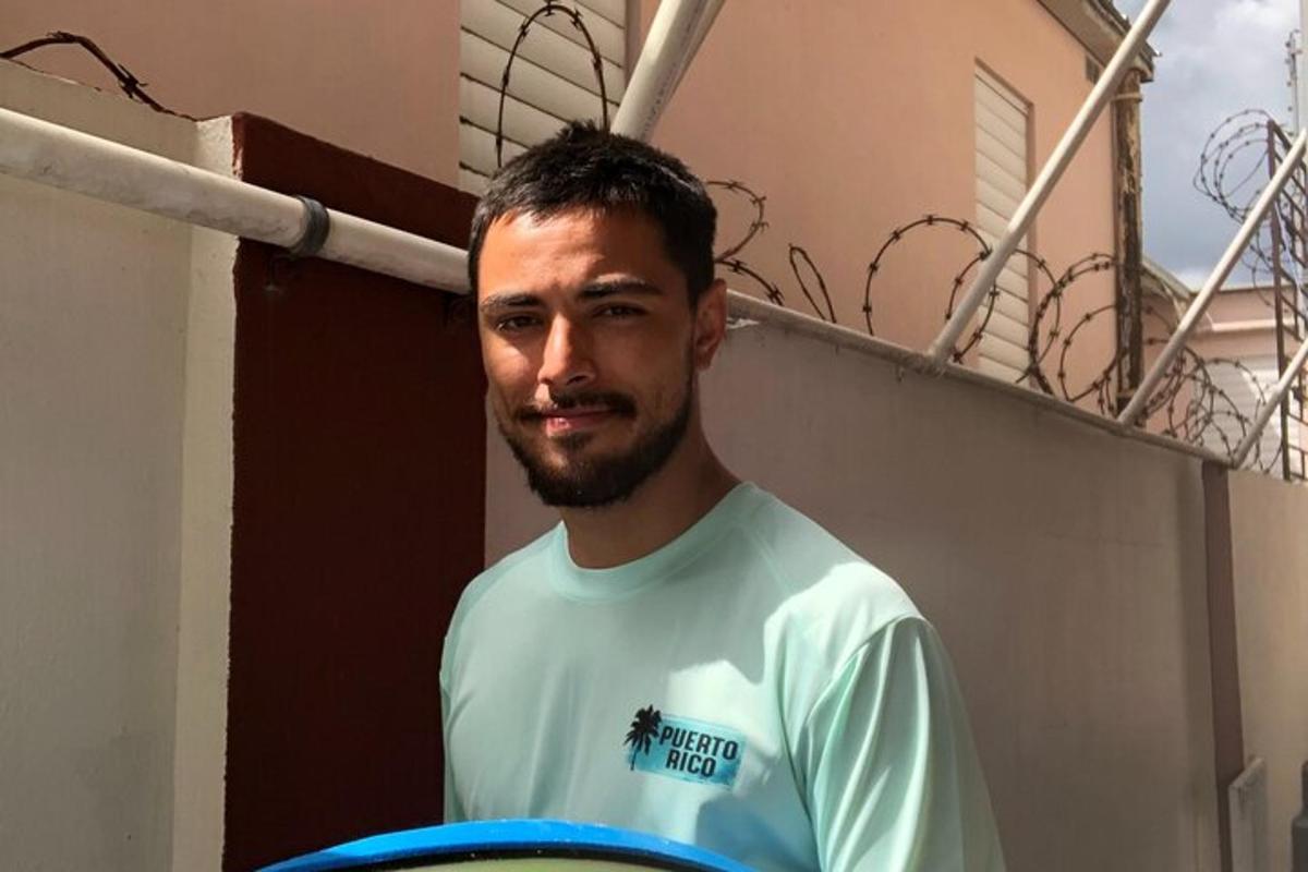 a man with a beard holding a blue frisbee