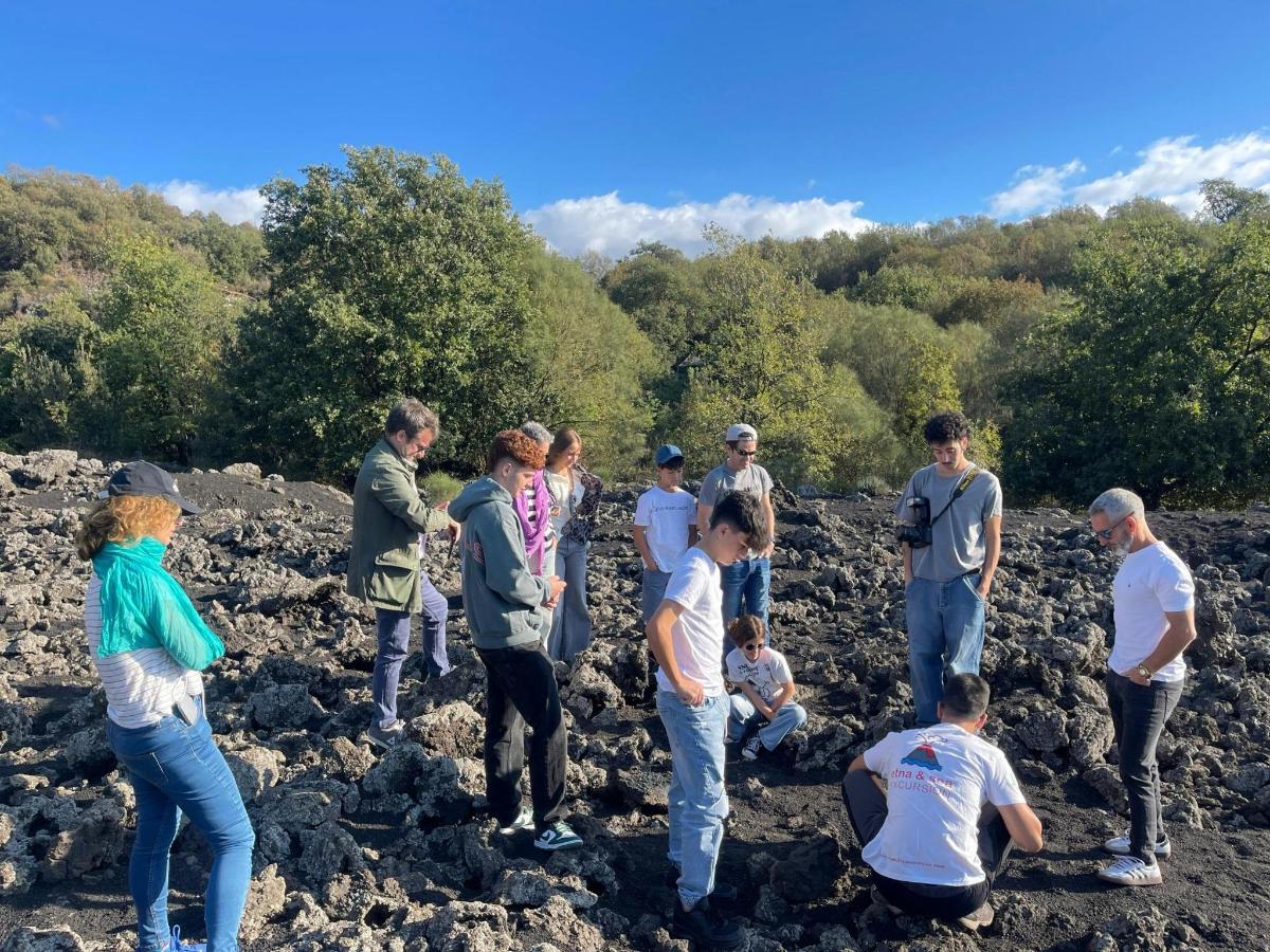 a group of people standing on some rocks