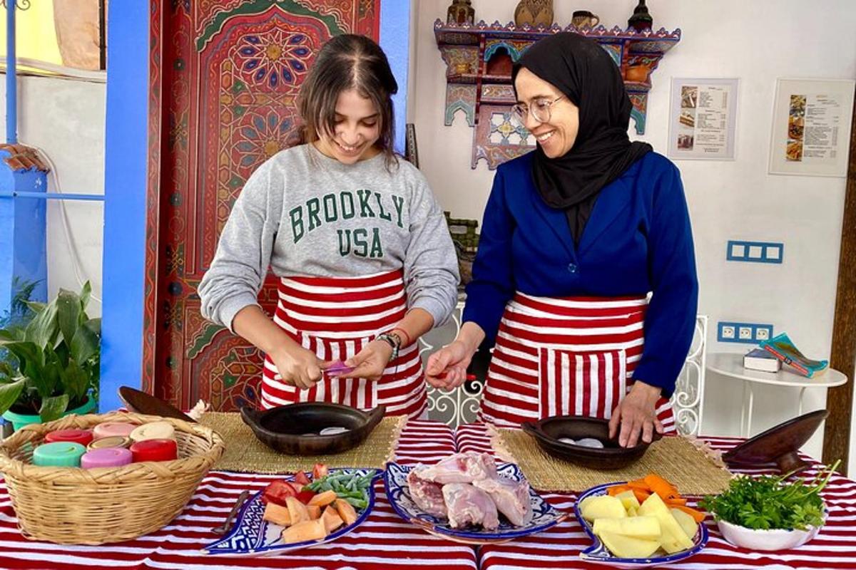 two women standing in front of a table with food
