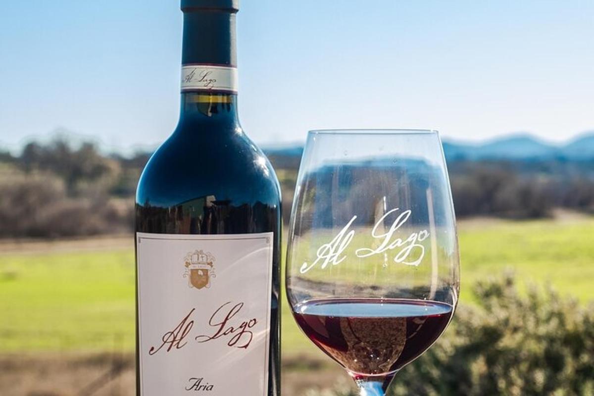a bottle of wine next to a glass of wine