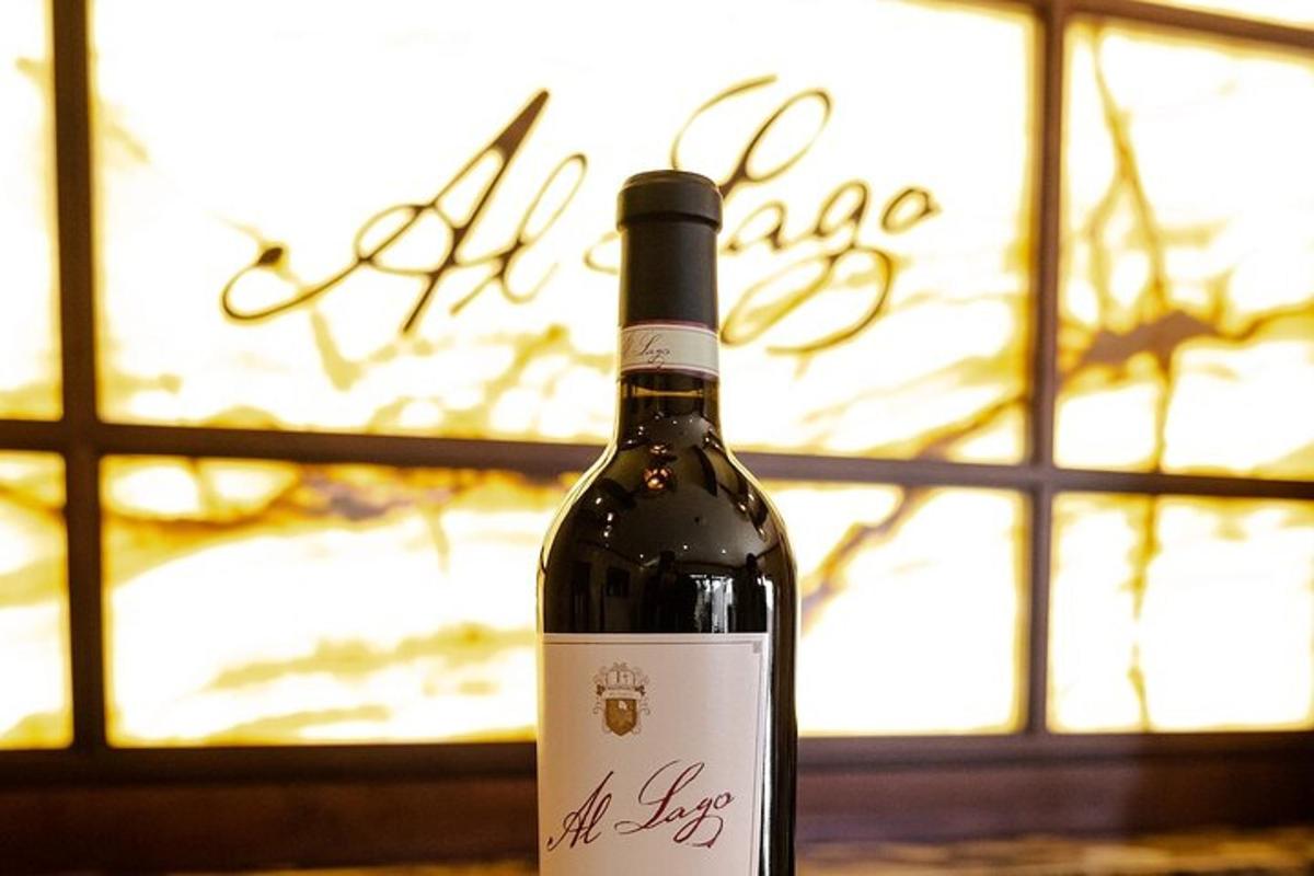 a bottle of wine sitting in front of a window