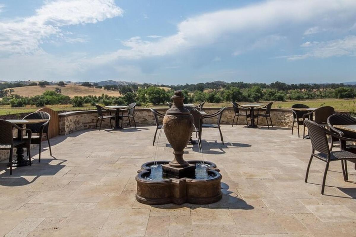 a fountain on a patio with tables and chairs